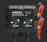 Noco GENIUS2X2 Battery Charger; Genius ®; For 6 Volt/ 12 Volt Batteries; 2 Bank Charger; 120 To 240 Volt AC Power Supply; 4 Amp Charging Current; 50 To 60 Hertz Frequency; -4 To 104 Degree Fahrenheit; 5.2 Inch Length x 1.9 Inch Width x 4.4 Inch Height; With Two Interchangeable Connectors/ Two Clamps With Integrated Eyelets/ Two 10 Foot Extension Cords/ Two Self-Tapping Screws/ Type A/ C/ G And I Power Cables